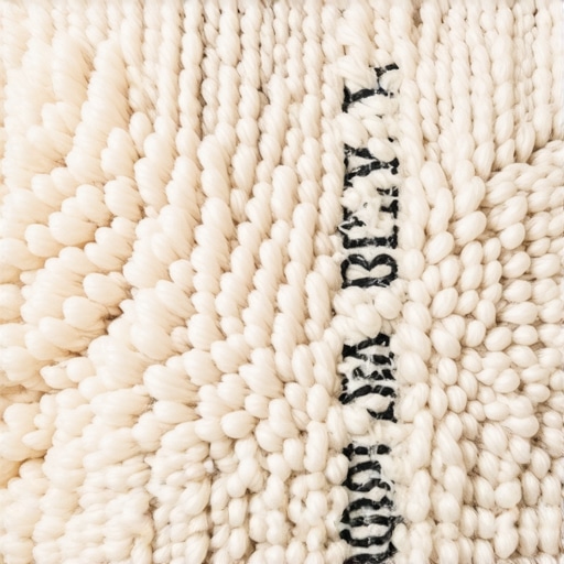 Close up of wool rug fibers showing the damage from scrubbing vs blotting.